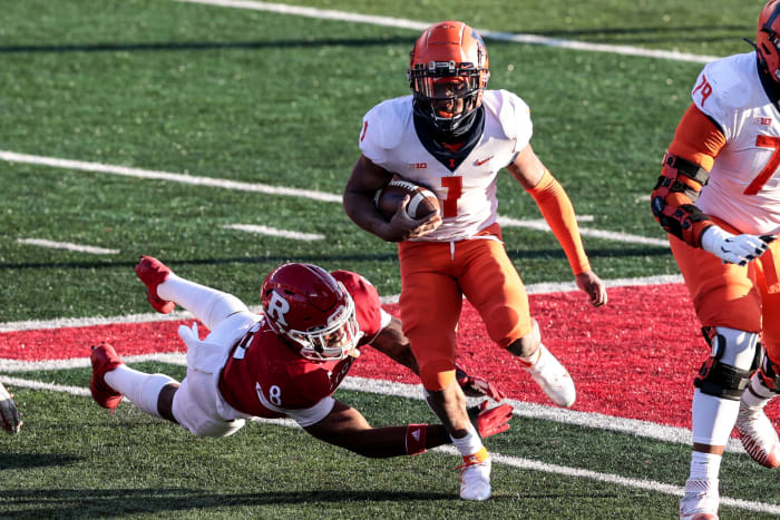 Illinois Fighting Illini quarterback Isaiah Williams (1) carries the ball as Rutgers Scarlet Knights linebacker Tyshon Fogg (8) dives for the tackle during the second half at SHI Stadium.